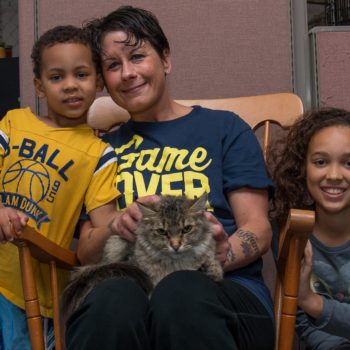 Happy family with adopted cat at Maddie's Pet Adoption Days 2015