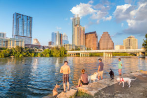 People and dogs with a view of Austin Texas downtown skyline
